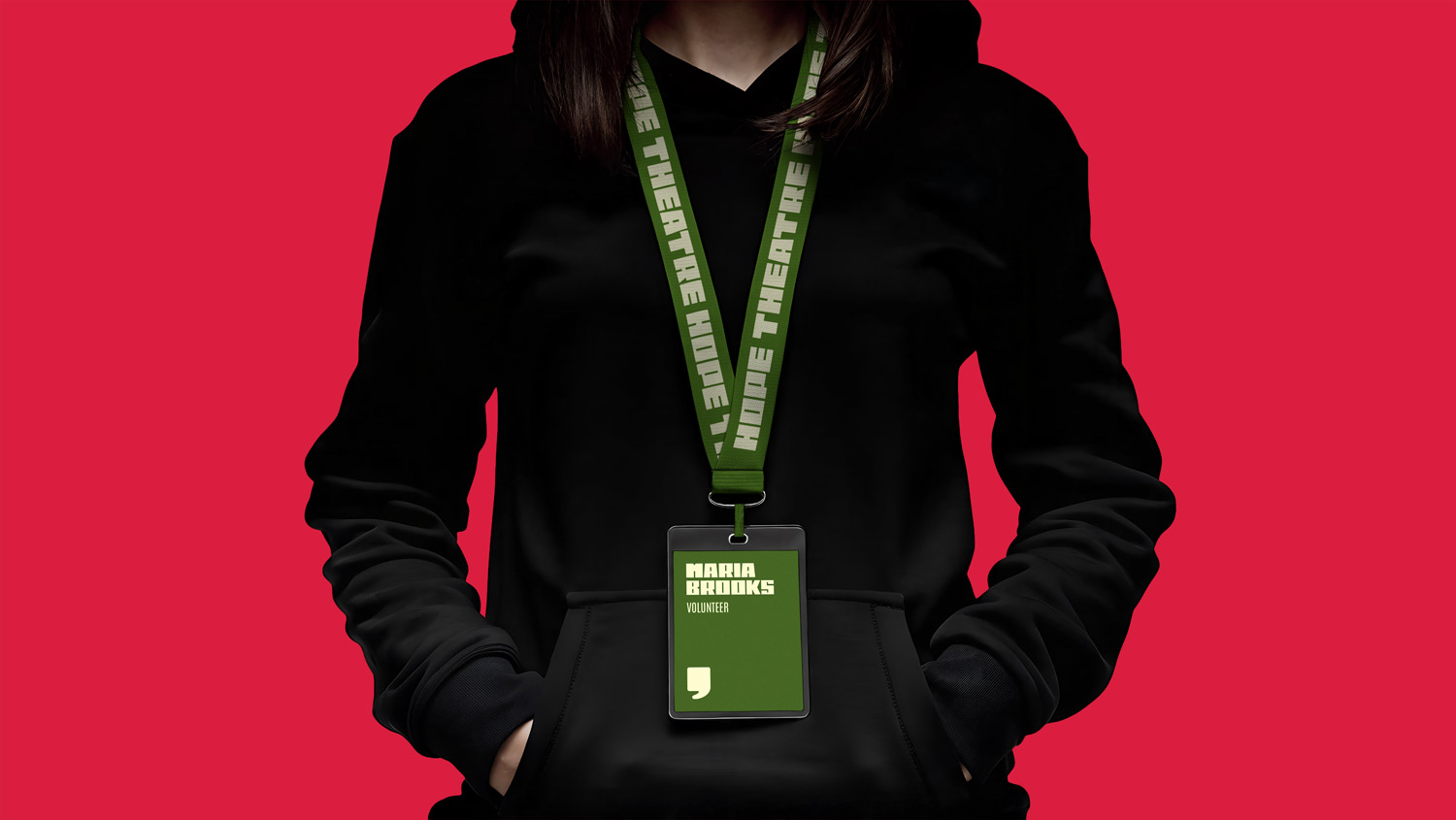 Image of a person in a black hoodie wearing a name tag with Hope Theatre branding.